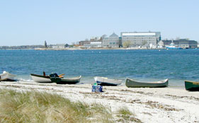 Some of the assortment of boats that were rowed over to Pine Island. The UConn Avery Point Campus is in the background.